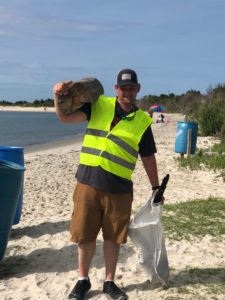 Volunteer at a Big Sweep Cleanup picking up trash.