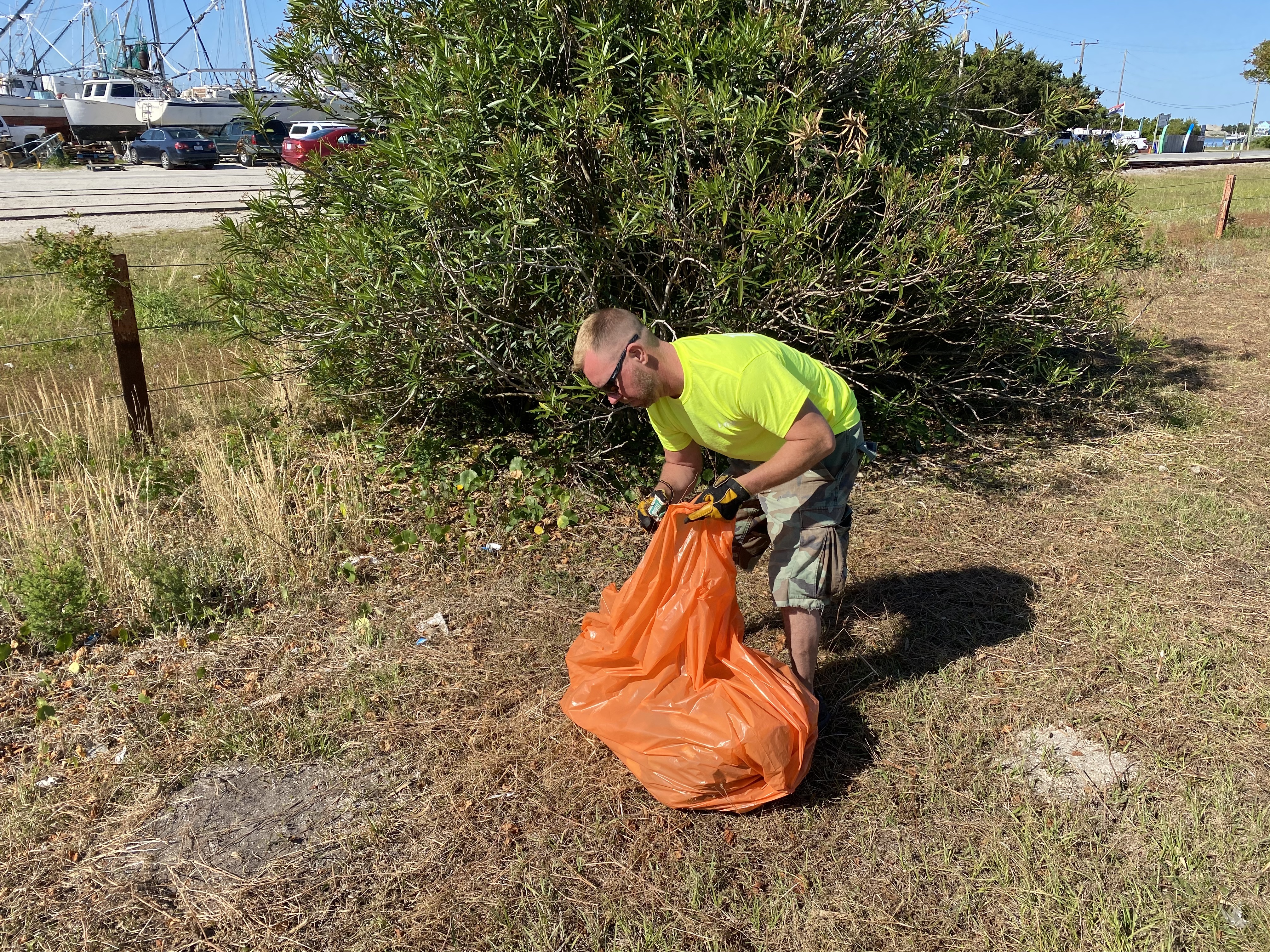 Volunteer picking up trash.