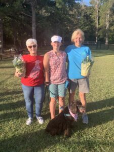 Judges Rosey Ward and Terry Murphy, pictured with 4-H'er Bethany Copeland and her dog, Melody