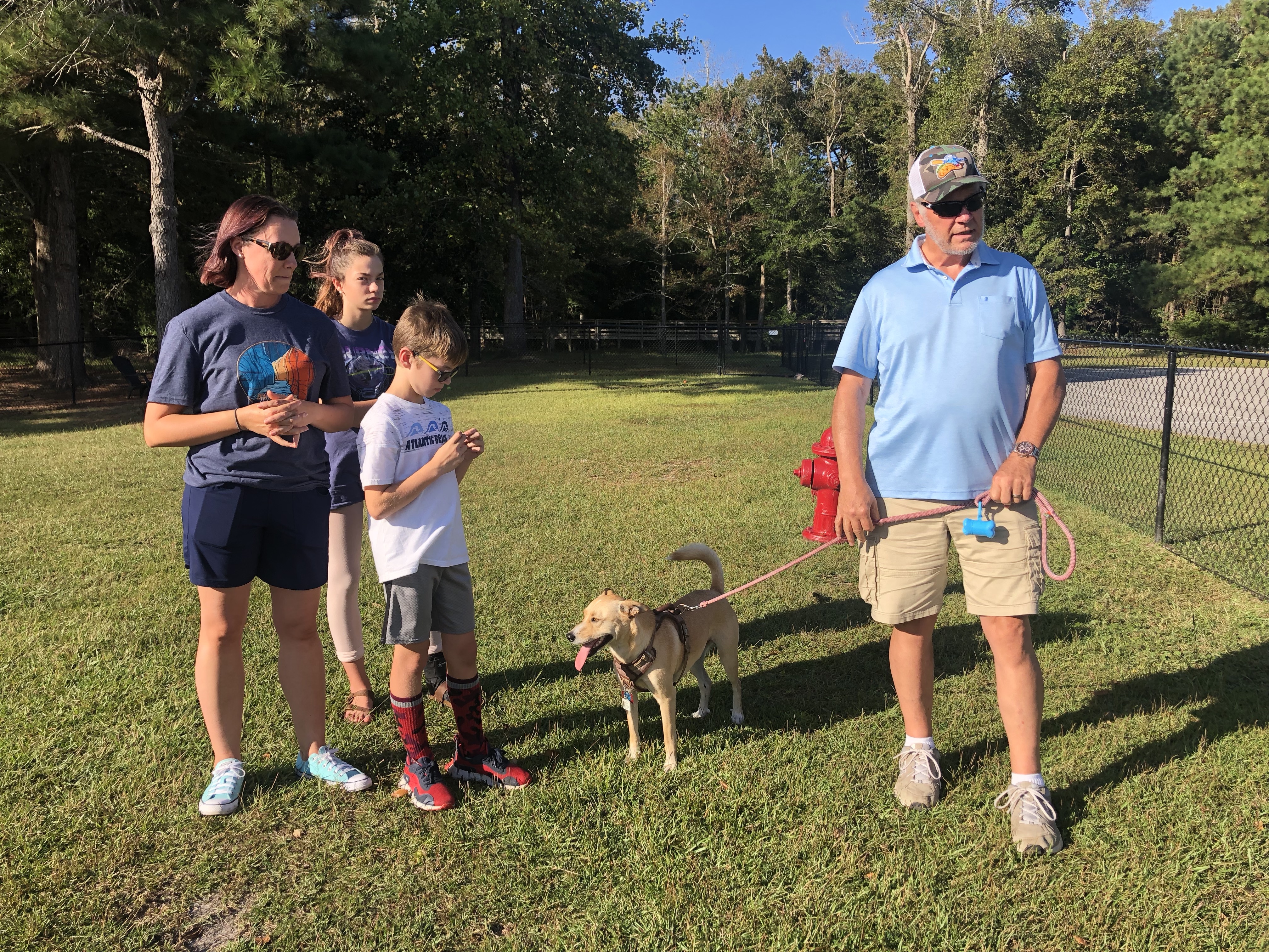 Tisha Kirby, foster with Misplaced Mutts, pictured with her children and her father, Roger Spencer, and his dog, Lucky
