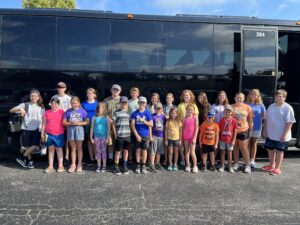 Bus and youth preparing to leave for camp.