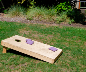 Cornhole board on lawn