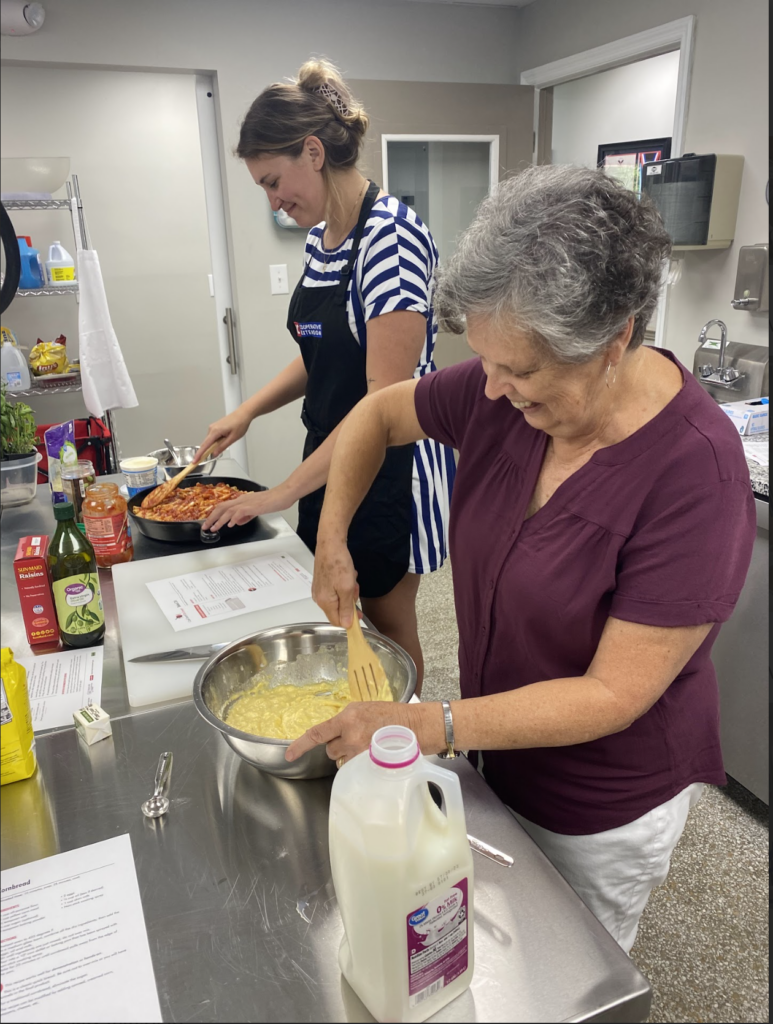 Picture of Stephanie Stevenson, FCS Agent, in the kitchen helping a participant with Cook Smart, Eat Smart program in Jones County.