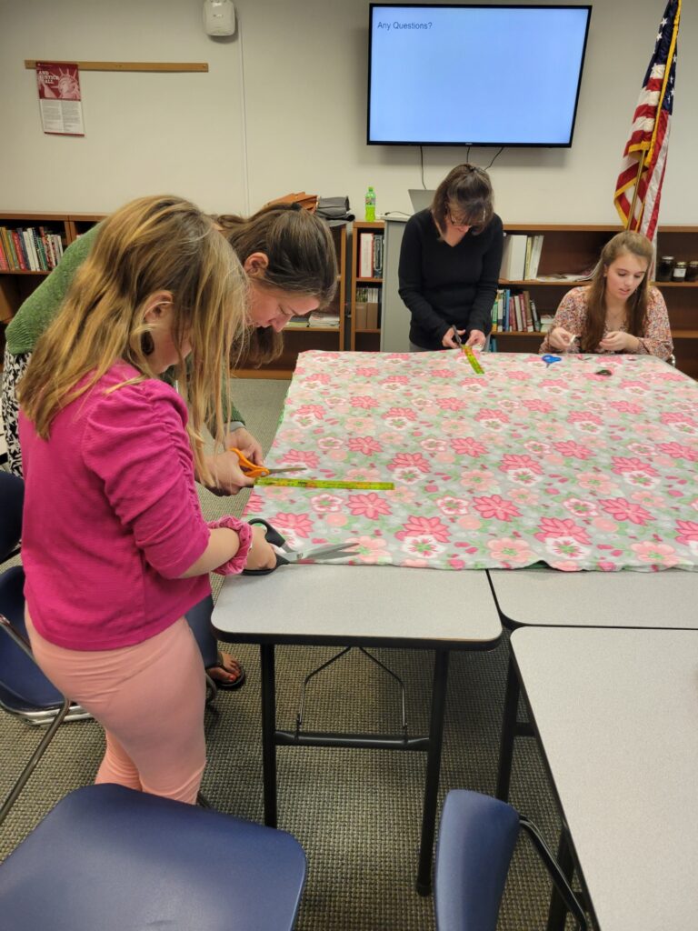 Carteret County 4-H members making blankets for service project.