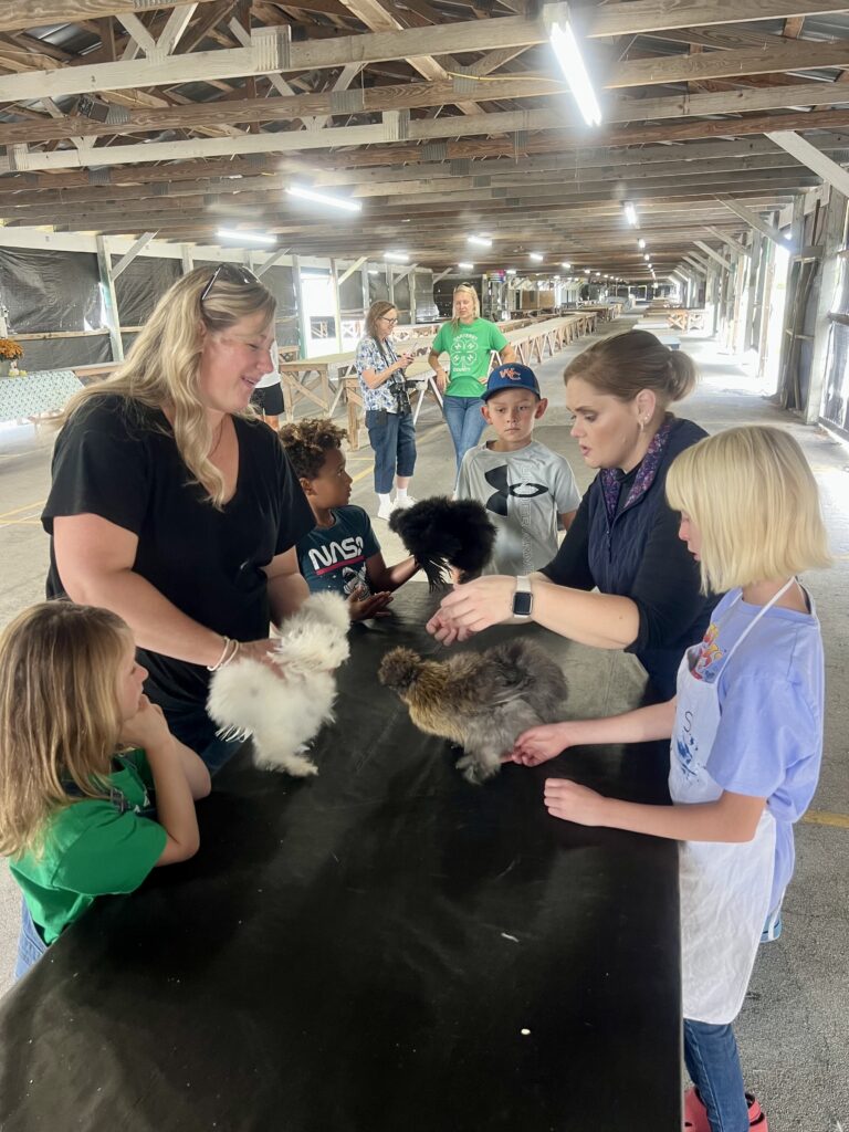 Tyre (judge) works one on one with youth and parents during showmanship clinic.